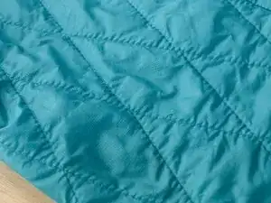 Repairing a Loop of Loose Stitching in a Patagonia Nano Puff ® Jacket