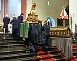 The small processional litter going up the choir stairs