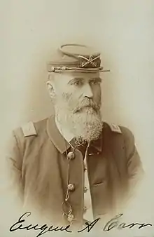 Signed sepia photo shows a bearded man wearing a dark military uniform. He wears a kepi on his head with the number 6.