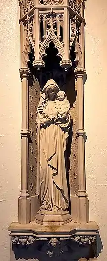 Marian Votive Shrine, Mother of the Good Shepherd. Carved in Caen stone, it was installed in the Lady Chapel in 1923 in honor of a parishioner's child who died in infancy.