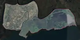 Aerial photo of an island partially subsconced beneath water.