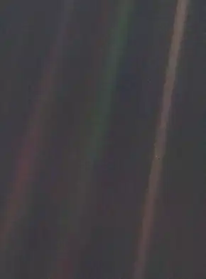 Image 1Pale Blue DotPhoto credit: NASA/JPLPale Blue Dot is the name given to this 1990 photo of Earth taken from Voyager 1 when its vantage point reached the edge of the Solar System, a distance of roughly 3.7 billion miles (6 billion kilometres). Earth can be seen as a blueish-white speck approximately halfway down the brown band to the right. The light band over Earth is an artifact of sunlight scattering in the camera's lens, resulting from the small angle between Earth and the Sun. Carl Sagan came up with the idea of turning the spacecraft around to take a composite image of the Solar System. Six years later, he reflected, "All of human history has happened on that tiny pixel, which is our only home."More selected pictures