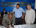 HEART Trust/NTA's previous Executive Director, Donald Foster, signs